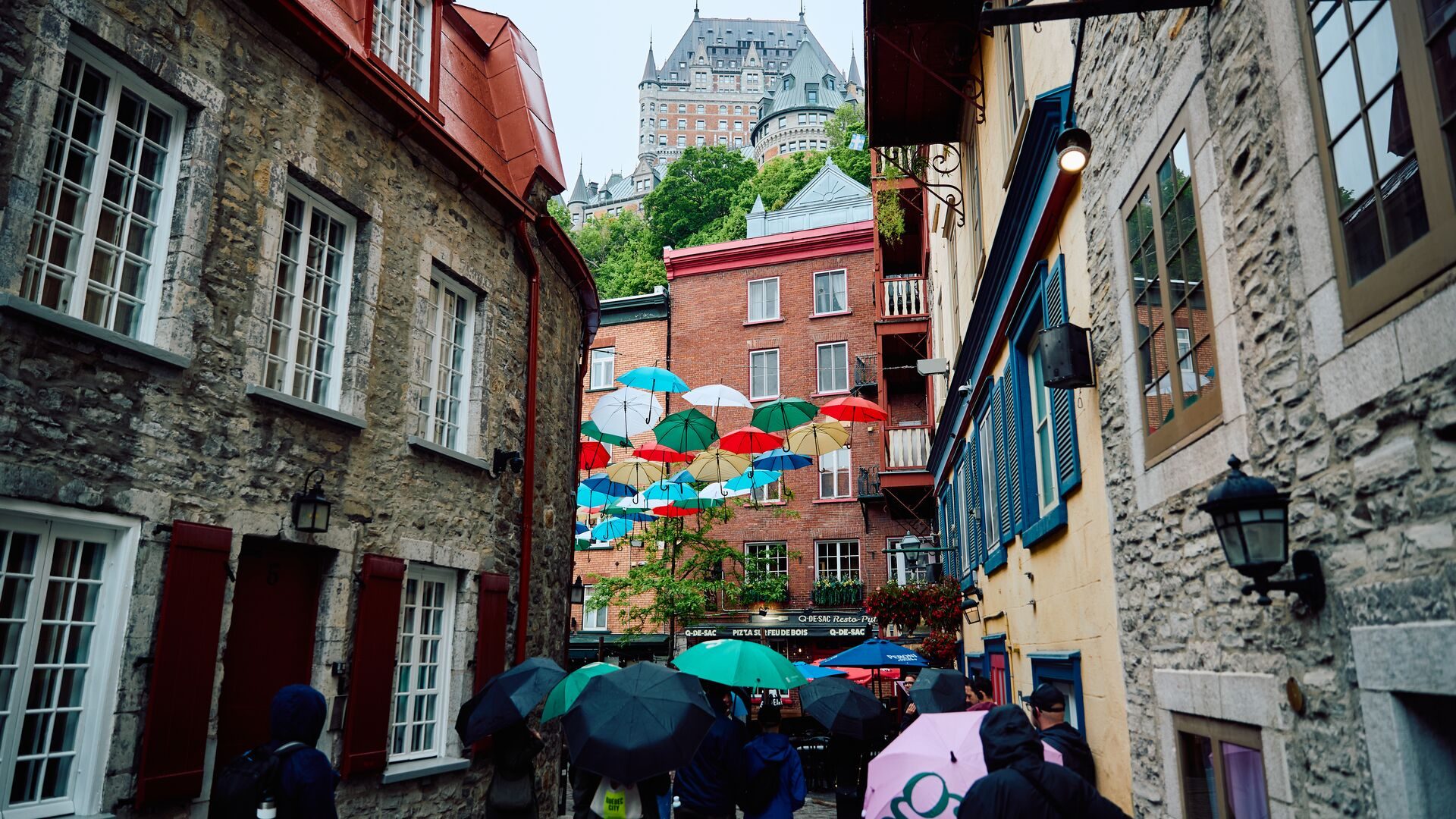 Art stalls under an awning along Rue du Trésor in Old Québec