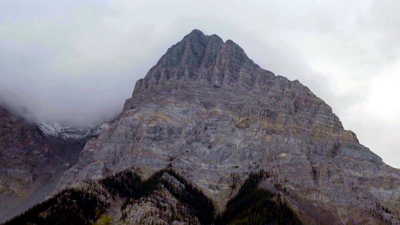 A grey rocky peak under cloud
