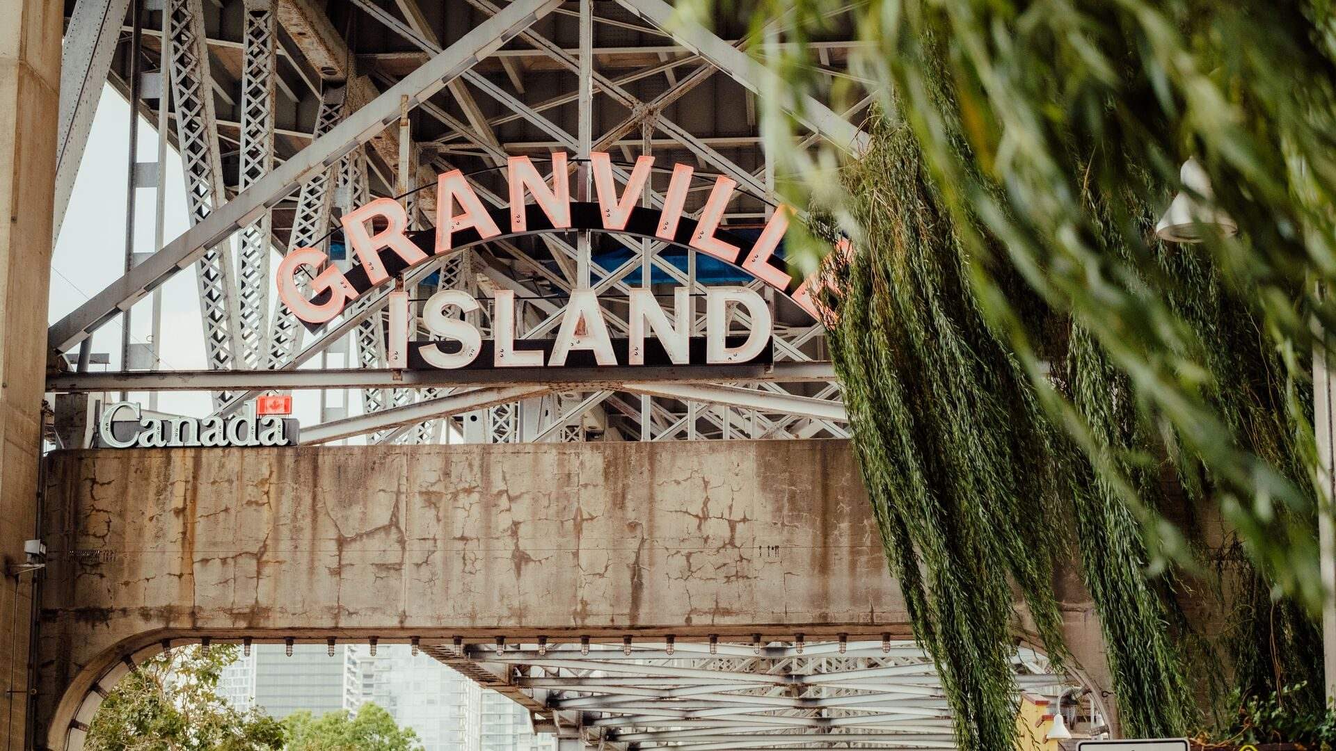 The Granville Island sign beneath the bridge