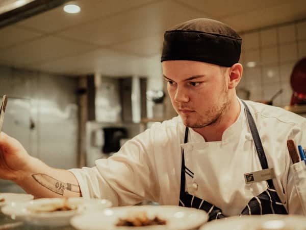 A chef plating a dish in a Lake Louise kitchen