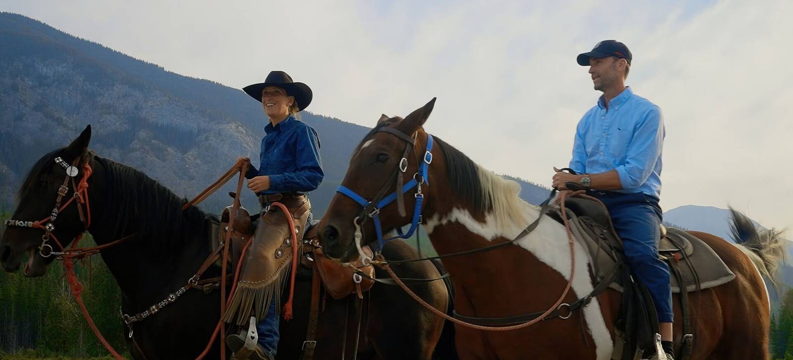 Two riders on horseback in the Banff foothills