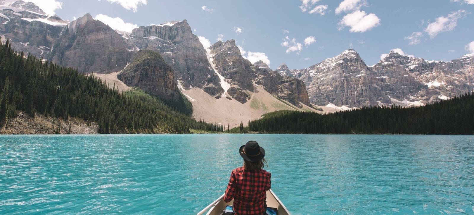 A paddler in a canoe on turquoise Moraine Lake