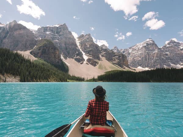 A paddler in a canoe on turquoise Moraine Lake