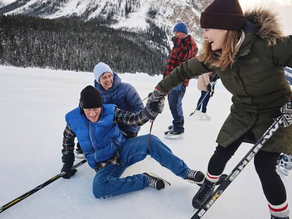 Skaters laughing on a frozen Banff lake